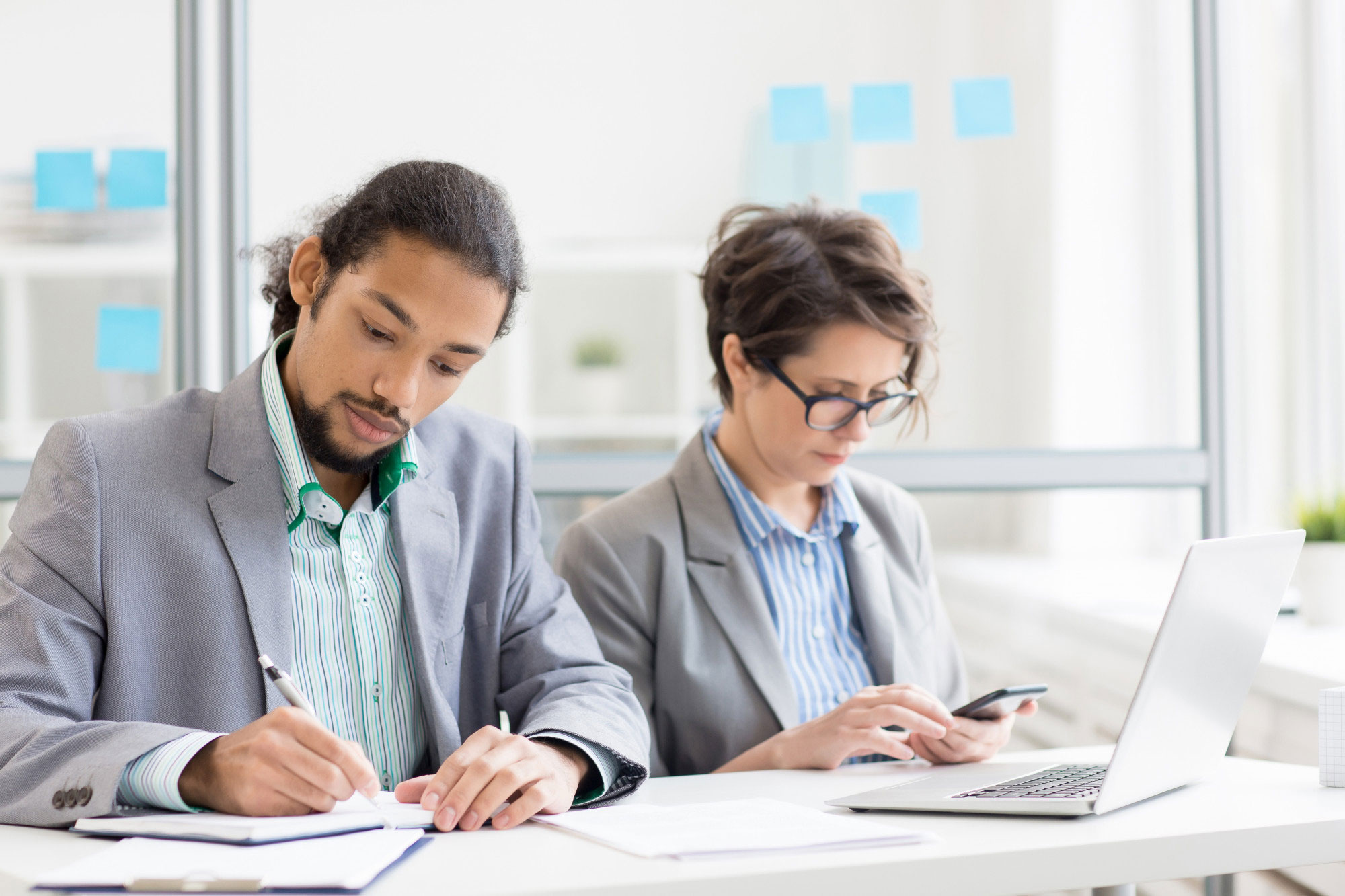 Two professionals reviewing translated documents at a desk